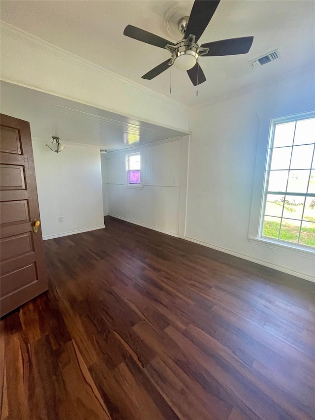 717 W Brazos St, Freeport, TX 77541 - spare room featuring dark wood-style flooring, ornamental molding, and ceiling fan