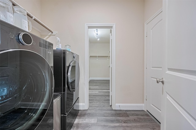 14538 Bending Maple Dr, Houston, TX 77069 - laundry area with separate washer and dryer and wood finished floors