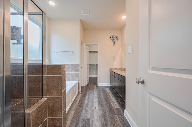 14538 Bending Maple Dr, Houston, TX 77069 - bathroom featuring a bath, vanity, wood finished floors, and a walk in closet