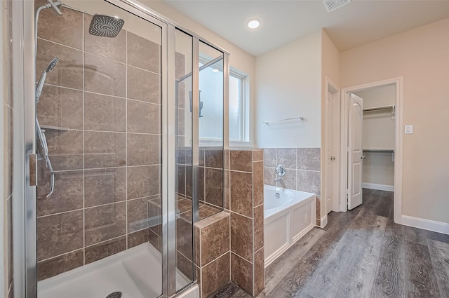 14538 Bending Maple Dr, Houston, TX 77069 - bathroom with a stall shower, a garden tub, wood finished floors, and a walk in closet
