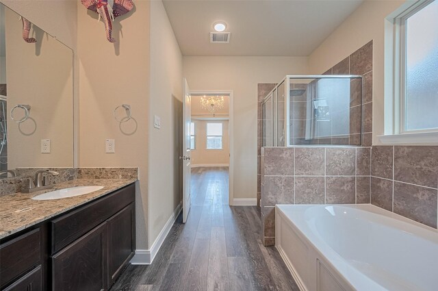 14538 Bending Maple Dr, Houston, TX 77069 - bathroom featuring wood finished floors, a stall shower, a garden tub, and vanity