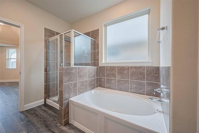 14538 Bending Maple Dr, Houston, TX 77069 - bathroom with wood finished floors, a bath, and a stall shower