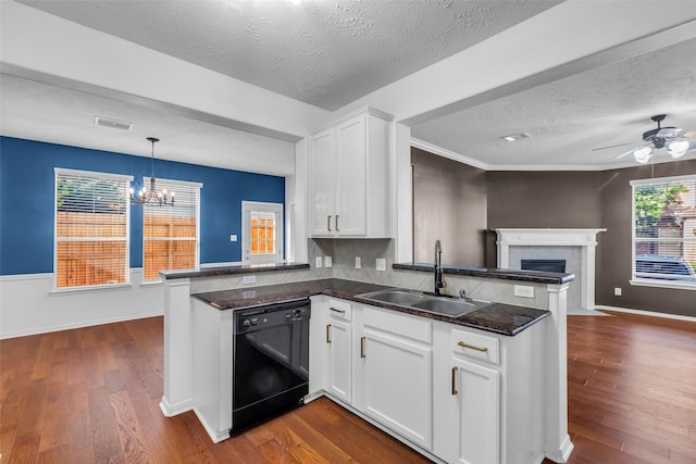 7402 Hollister Rdg, Houston, TX 77040 - kitchen featuring a peninsula, dishwasher, open floor plan, dark wood-style flooring, and a textured ceiling