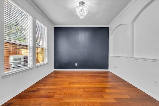7402 Hollister Rdg, Houston, TX 77040 - spare room with healthy amount of natural light, a chandelier, wood finished floors, and crown molding