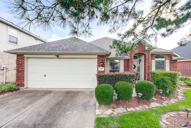 17906 Keenan Cv, Houston, TX 77084 - view of front of home with brick siding, driveway, a shingled roof, and an attached garage