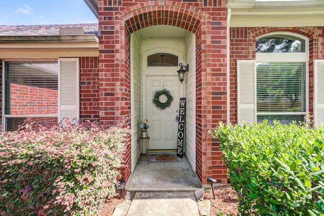 17906 Keenan Cv, Houston, TX 77084 - view of exterior entry with brick siding and roof with shingles