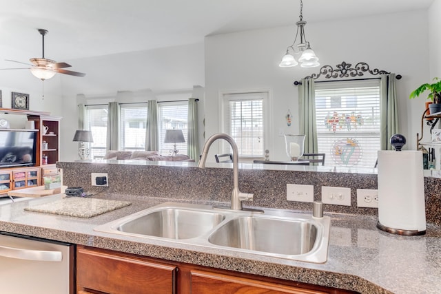 17906 Keenan Cv, Houston, TX 77084 - kitchen with dishwasher, brown cabinetry, a ceiling fan, open floor plan, and hanging light fixtures