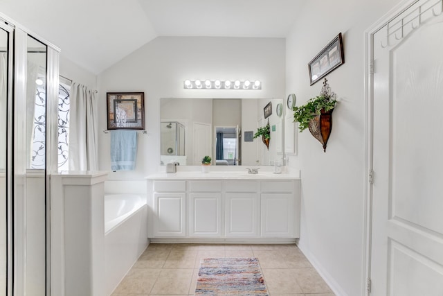17906 Keenan Cv, Houston, TX 77084 - bathroom with double vanity, a garden tub, a shower stall, tile patterned floors, and vaulted ceiling
