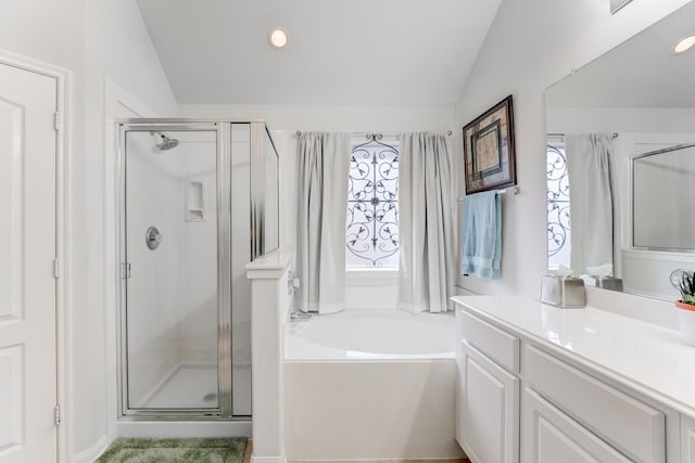 17906 Keenan Cv, Houston, TX 77084 - bathroom with a stall shower, vaulted ceiling, a garden tub, vanity, and recessed lighting