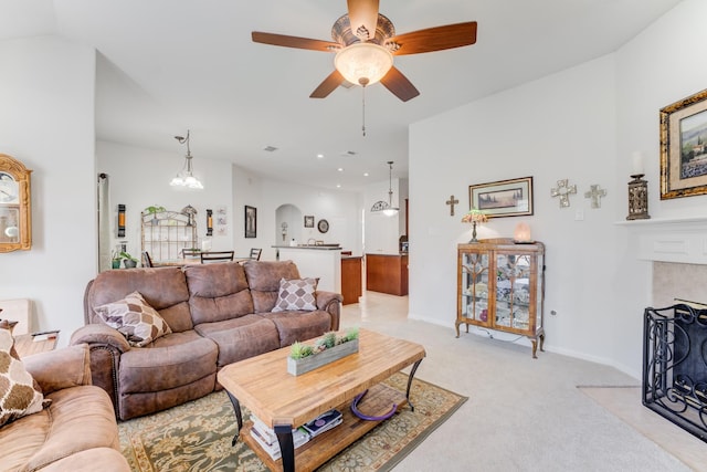 17906 Keenan Cv, Houston, TX 77084 - living area featuring a fireplace with flush hearth, light colored carpet, ceiling fan, and arched walkways
