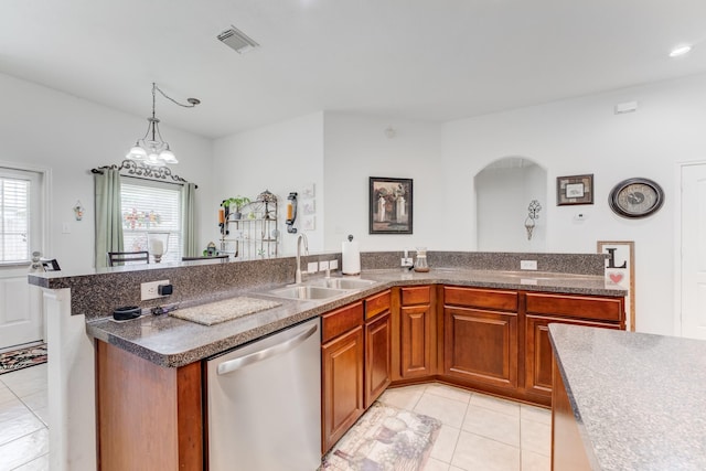 17906 Keenan Cv, Houston, TX 77084 - kitchen with dishwasher, light tile patterned floors, arched walkways, brown cabinetry, and recessed lighting