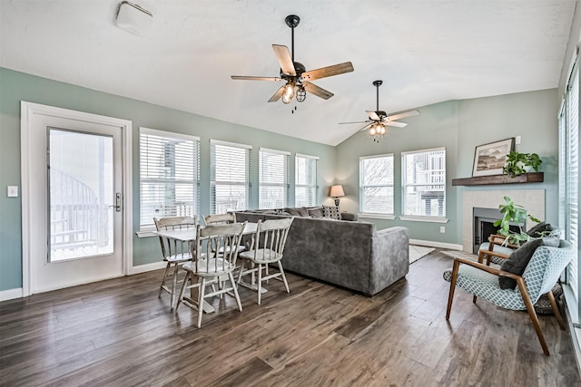 4023 Spanish Main Blvd, Galveston, TX 77554 - living area with dark wood-type flooring, a ceiling fan, vaulted ceiling, and a tile fireplace