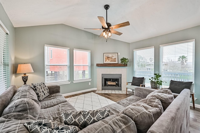 4023 Spanish Main Blvd, Galveston, TX 77554 - living room featuring vaulted ceiling, a ceiling fan, wood finished floors, and a tiled fireplace