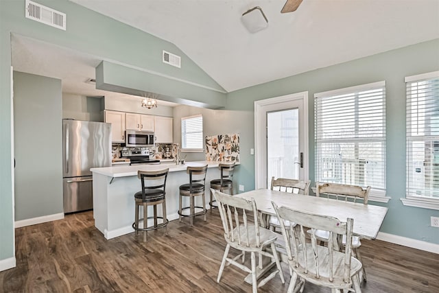 4023 Spanish Main Blvd, Galveston, TX 77554 - dining room with lofted ceiling and dark wood-type flooring
