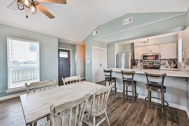 4023 Spanish Main Blvd, Galveston, TX 77554 - dining space with vaulted ceiling, dark wood-style flooring, and ceiling fan