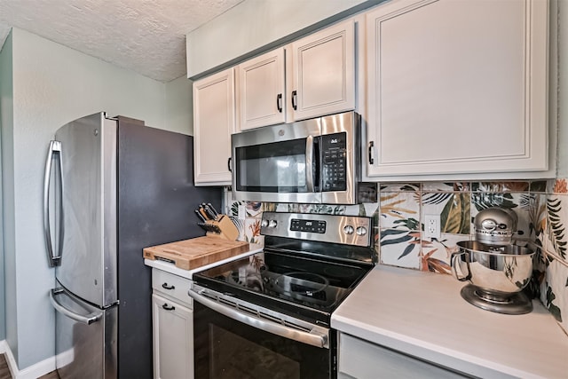4023 Spanish Main Blvd, Galveston, TX 77554 - kitchen with stainless steel appliances, light countertops, tasteful backsplash, and a textured ceiling