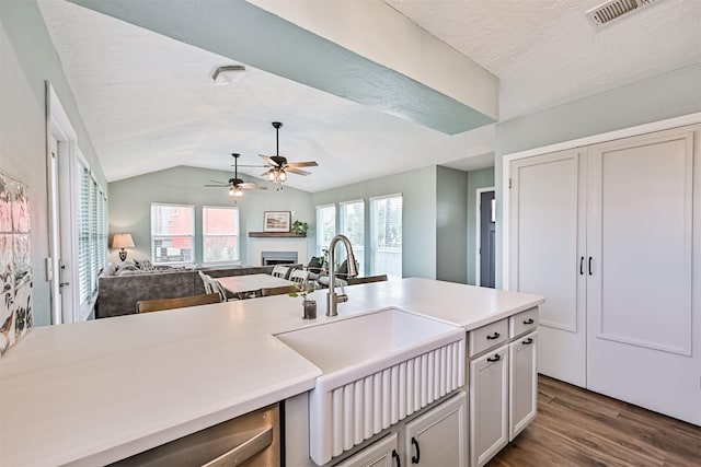 4023 Spanish Main Blvd, Galveston, TX 77554 - kitchen featuring wood finished floors, ceiling fan, a fireplace, open floor plan, and light countertops