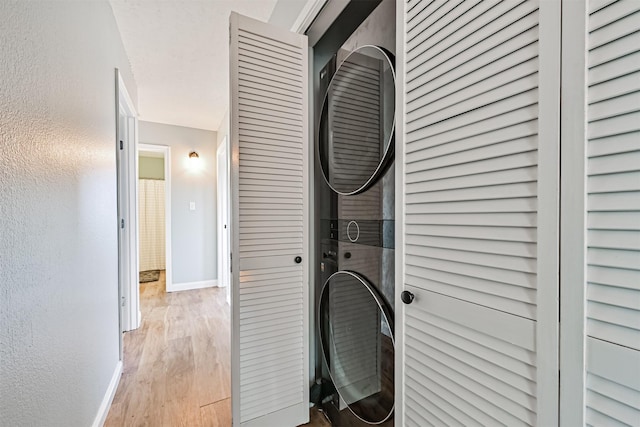 4023 Spanish Main Blvd, Galveston, TX 77554 - laundry area featuring stacked washing machine and dryer and light wood finished floors