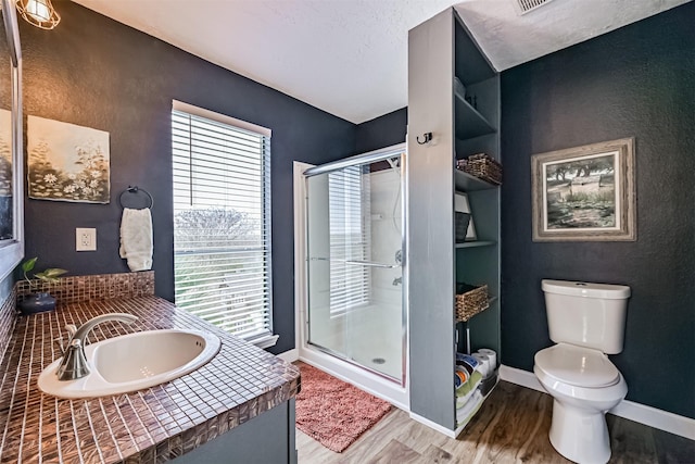4023 Spanish Main Blvd, Galveston, TX 77554 - bathroom with wood finished floors, a stall shower, vanity, and a textured wall