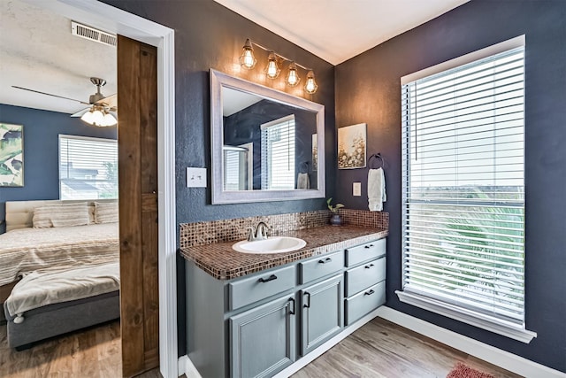 4023 Spanish Main Blvd, Galveston, TX 77554 - ensuite bathroom with vanity, wood finished floors, and ceiling fan