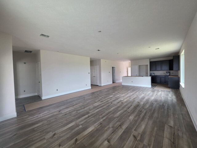 2035 Winepress Rd, Brenham, TX 77833 - unfurnished living room featuring wood finished floors and baseboards