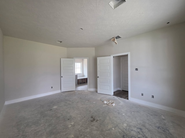 2035 Winepress Rd, Brenham, TX 77833 - unfurnished bedroom featuring a textured ceiling and connected bathroom