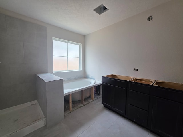2035 Winepress Rd, Brenham, TX 77833 - bathroom featuring a bath and tiled shower