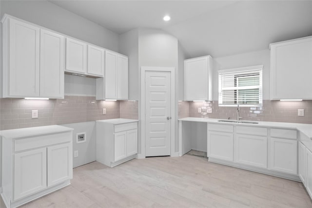 6622 Old Cypress Landing Ln, Humble, TX 77338 - kitchen with tasteful backsplash, light wood-style floors, white cabinetry, lofted ceiling, and recessed lighting