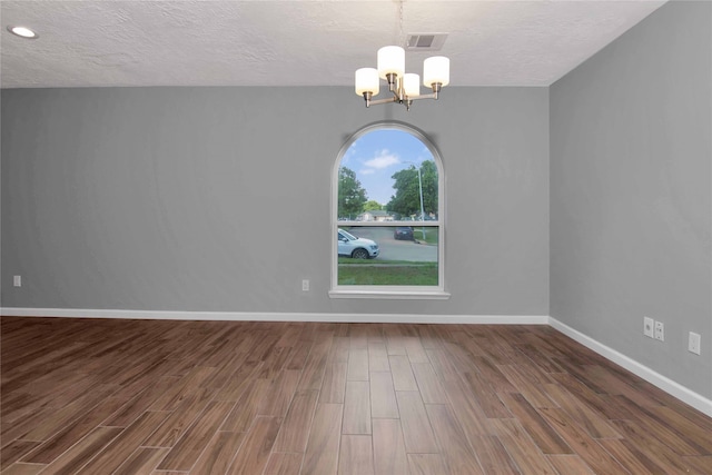 12811 Golden Tee Ln, Houston, TX 77099 - unfurnished room featuring a chandelier, a textured ceiling, and wood finished floors
