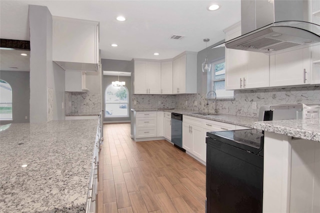 12811 Golden Tee Ln, Houston, TX 77099 - kitchen with island exhaust hood, dishwasher, backsplash, white cabinets, and recessed lighting