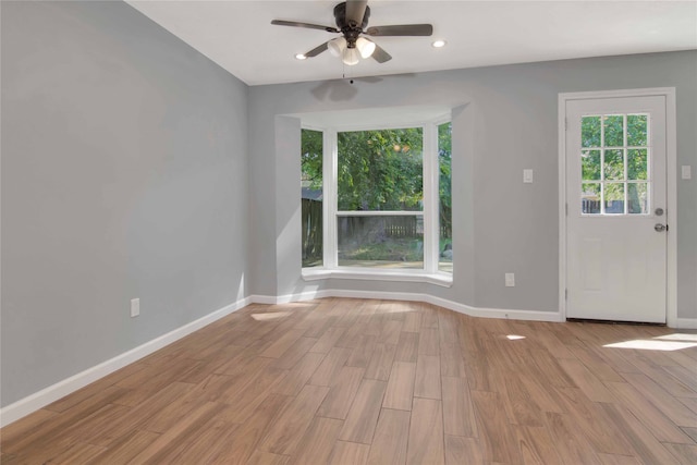 12811 Golden Tee Ln, Houston, TX 77099 - unfurnished living room featuring ceiling fan, light wood-type flooring, and recessed lighting