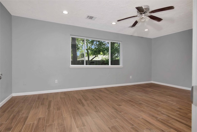 12811 Golden Tee Ln, Houston, TX 77099 - spare room featuring wood finished floors, ceiling fan, a textured ceiling, and recessed lighting