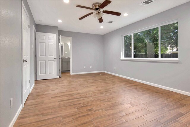 12811 Golden Tee Ln, Houston, TX 77099 - unfurnished bedroom featuring light wood-style floors, recessed lighting, connected bathroom, and ceiling fan