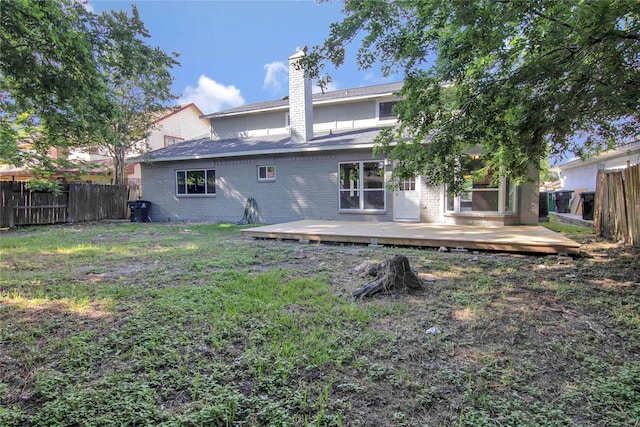 12811 Golden Tee Ln, Houston, TX 77099 - back of house with a fenced backyard, a wooden deck, a chimney, and brick siding