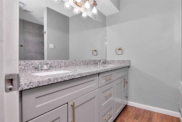 12811 Golden Tee Ln, Houston, TX 77099 - full bathroom with double vanity and wood finished floors