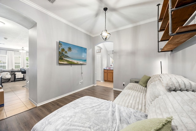 3015 Crescent Oaks Park Ln, Spring, TX 77386 - bedroom with arched walkways, wood finished floors, crown molding, and ensuite bathroom