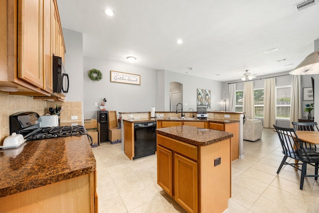 3015 Crescent Oaks Park Ln, Spring, TX 77386 - kitchen with black appliances, a center island with sink, arched walkways, tasteful backsplash, and light tile patterned floors