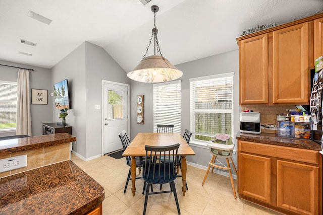3015 Crescent Oaks Park Ln, Spring, TX 77386 - dining area with light tile patterned floors and vaulted ceiling