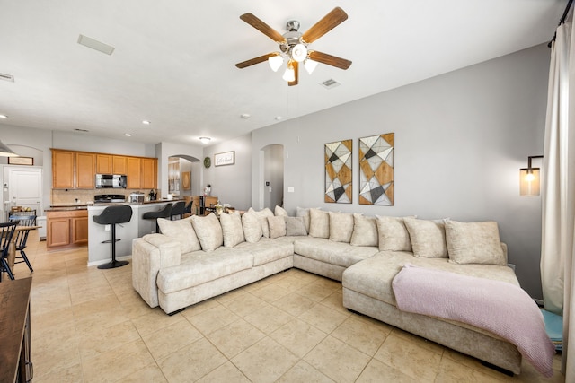 3015 Crescent Oaks Park Ln, Spring, TX 77386 - living area featuring arched walkways, a ceiling fan, light tile patterned flooring, and recessed lighting
