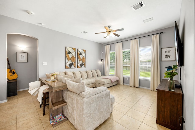 3015 Crescent Oaks Park Ln, Spring, TX 77386 - living room featuring arched walkways, ceiling fan, and light tile patterned flooring