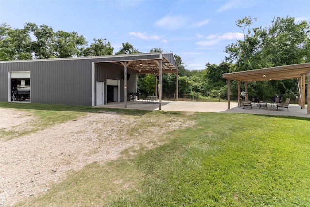 500 E Main St, Clute, TX 77531 - view of home's community with a detached garage, a yard, an outdoor structure, and a pole building