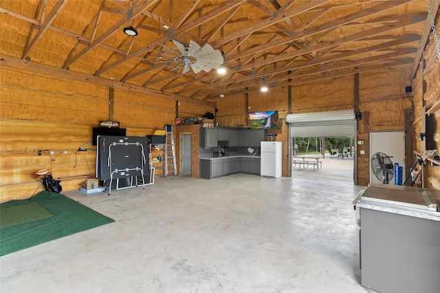 500 E Main St, Clute, TX 77531 - garage featuring freestanding refrigerator and wood walls