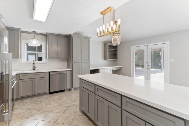500 E Main St, Clute, TX 77531 - kitchen with dishwasher, gray cabinets, tasteful backsplash, and french doors