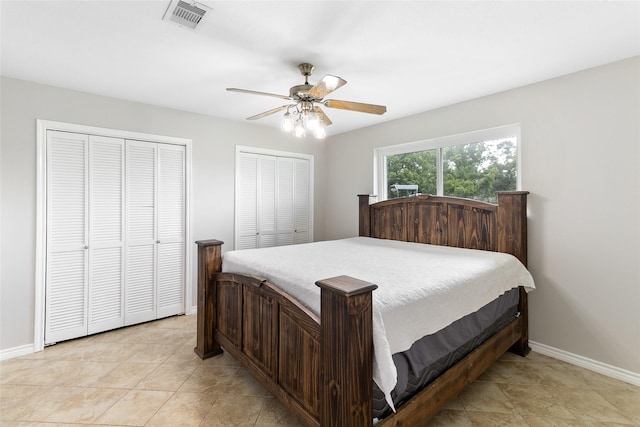 500 E Main St, Clute, TX 77531 - bedroom with two closets, ceiling fan, and light tile patterned floors