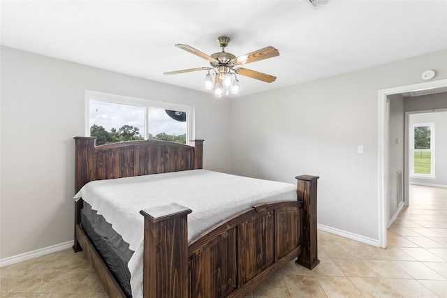 500 E Main St, Clute, TX 77531 - bedroom featuring a ceiling fan, attic access, and light tile patterned floors
