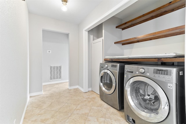 500 E Main St, Clute, TX 77531 - laundry room featuring washing machine and clothes dryer and light tile patterned flooring