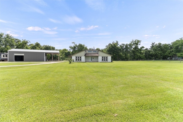 500 E Main St, Clute, TX 77531 - view of grassy yard featuring a pole building, an outbuilding, and a garage