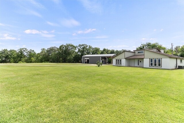 500 E Main St, Clute, TX 77531 - view of green lawn featuring view of wooded area