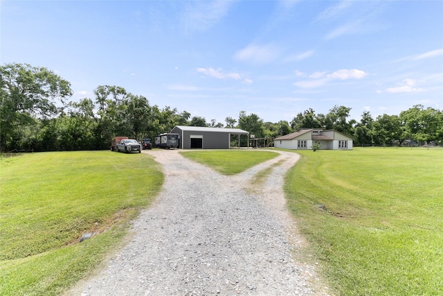 500 E Main St, Clute, TX 77531 - view of front of house with driveway, a carport, a front lawn, and an outbuilding