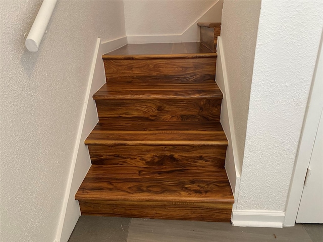 6201 Ranchester Dr Unit 48, Houston, TX 77036 - stairway featuring a textured wall and wood finished floors